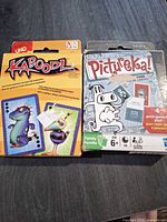 Front view of Kaboodl and Pictureka! card game boxes