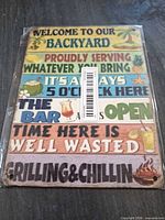 Front of packaged multicolor wooden sign showing text and graphics