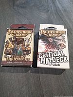 Front view of both Pathfinder card deck boxes