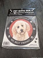 Front of packaged Labradoodle car magnet showing design and branding