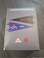 Front of retail box showing images of both sides of the reversible pennant