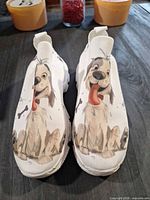front view of sneakers showing dog graphic