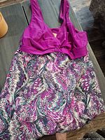 Front view showing purple/magenta bodice and multicolor skirt