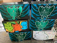 Six decorative Elite Trainer Box storage boxes stacked