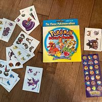 Group shot showing sealed Scratchees box, sticker sheet and tattoo sheets