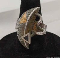 Front view of textured sterling silver ring with geometric face