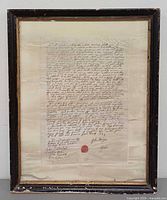 Full view of framed document showing frame and matting