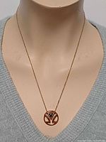 Full view of necklace on mannequin bust showing pendant placement