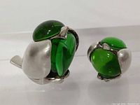 Pair of Christofle silver-plated bird figurines front view showing green cabochon bodies