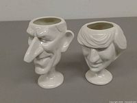 Front view of both caricature egg cups