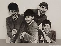 Front view of black & white Beatles cardboard standee