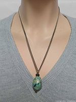 Necklace front view on mannequin showing pendant position and chain length