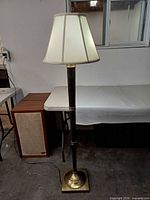 Full view of lamp illuminated with shade on