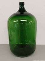 Front view of emerald green glass carboy