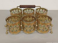 Six glasses seated in carrier rack
