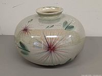 Front view showing floral design and crackle glaze