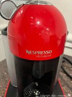 Close view of Nespresso VertuoLine branding on red housing