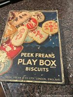 Front view of Peek Frean's Play Box biscuit tin showing graphics and branding