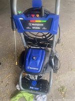 Full view of Westinghouse WPX3000e pressure washer showing frame, hose, wand and front labeling