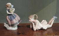 Both porcelain figurines side by side on table