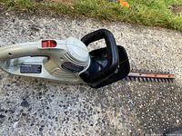 Full view of hedge trimmer showing handles and blade