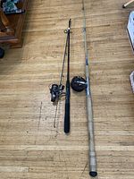 Two rods and reels laid out for size comparison