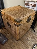 Front view of wicker cube chest showing latch and corner hardware