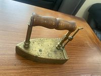 Side view of brass iron with wood handle