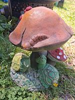 Front view showing mushroom cap with caterpillar and two turtles at base