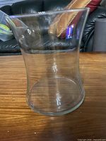 Front view of clear crystal vase, showing flared rim and cylindrical body