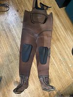 Full view of brown neoprene chest waders showing boots and knee pads