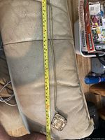 Full necklace laid beside tape measure showing 28 inch length