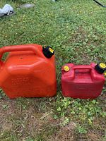 Both gasoline cans side by side on grass