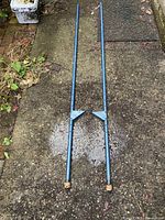 Full view of both stilts laid on pavement