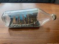full side view of bottle showing entire ship and scene