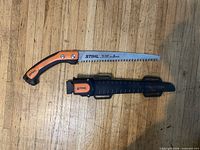 Saw and scabbard laid out on floor