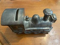 Side view of metal steam locomotive bank
