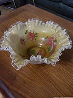Top view showing ruffled clear crest edge and floral paint
