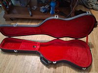 Case open showing red plush interior and accessory compartment