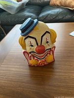 Front view of porcelain clown head planter showing colors and design