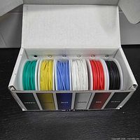 Open box showing six color-coded wire spools