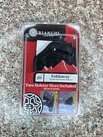 Sealed retail blister pack showing both holsters and labeling