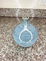 Front view of bulbous blue-grey vase with white accent ring