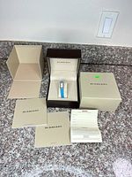 Entire lot showing watch inside presentation box, outer box, documents and tag