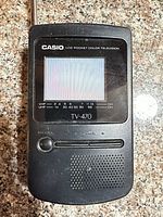 Front view showing LCD display, speaker grille and controls