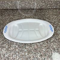 Top view of white oval platter with blue floral ends