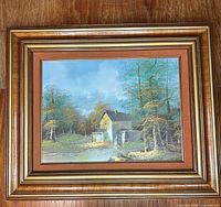 Full view of framed landscape painting