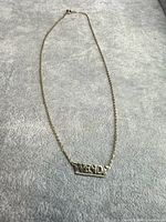 Full view of necklace laid flat showing chain length and pendant