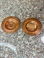 Two hammered copper bowls shown top view
