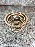 Angled view of candle holder showing glaze and cutouts